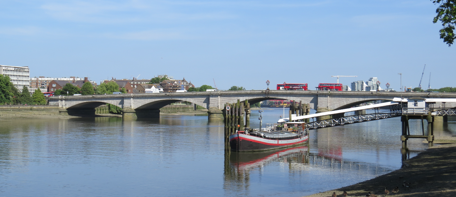 Putney bridge with London buses driving over it